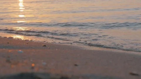 Sea waves rolling on the shore at sunset Stock Footage 72239388