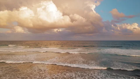 Sea waves rolling in under dramatic clouds during tropical sunset Stock Footage 315661001