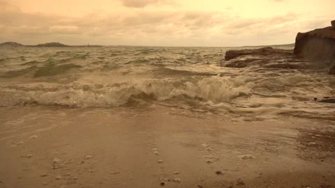 Sea waves run onto the sandy beach in summer in cloudy weather Stock Footage 131883305