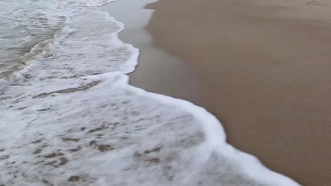 Sea waves run to an sandy beach Stock Footage 153998498