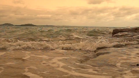 Sea waves run onto the sandy shore in the evening Stock Footage 131883853