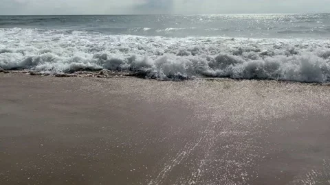 Sea waves on sand beach, Wave crashing against sand beach Stock Footage 167739123