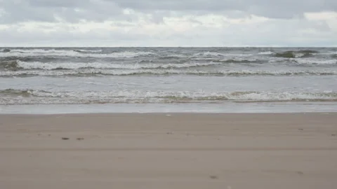 Sea waves on sandy beach at ground level in Jurmala Latvia resort town 스톡 동영상 325973690