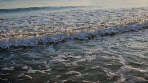 Sea waves on the sandy beach. ocean beach waves on beach at sunset time Video stock 122919642