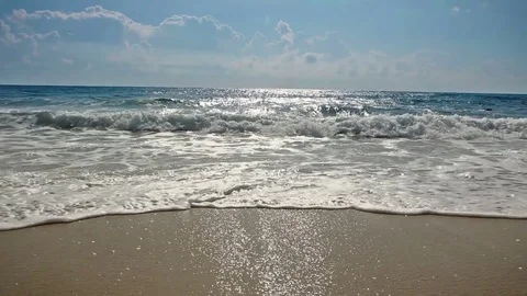 Sea waves on sandy beach, sunshine, cloudy sky Stock-Footage 70125160