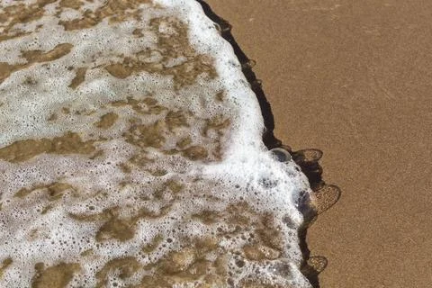 Sea waves on sandy beach, top view, sunny day.. sea waves on sandy beach, top Stock Photos