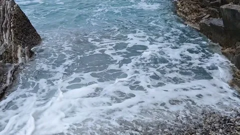 Sea waves scraping pebbles on a beach Stock Footage 255194973