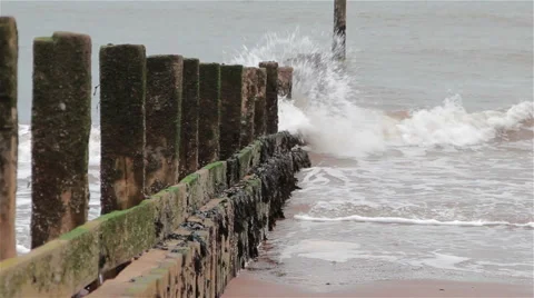 Sea Waves Splash along the line of a Wave Breaker on Sand Beach Stock-Footage 46510415