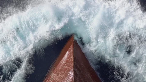 Sea waves splashes against red forward part of modern vessel Stock Footage 117110070