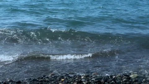Sea waves with splashes of water break on the rocky shore. Stock Footage 128142600