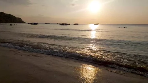 Sea waves splashing on the beach at sunset. Stock Footage 280449945