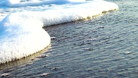 Sea waves splashing sandy beach, close up. Stock Footage 144639244