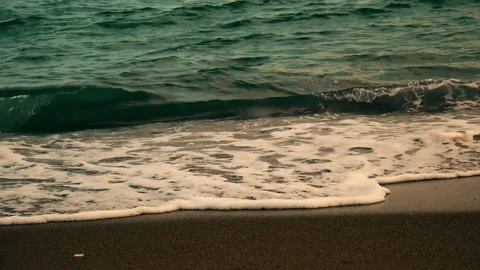 Sea waves splashing sandy beach at the end of summer day Stock Footage 145089186