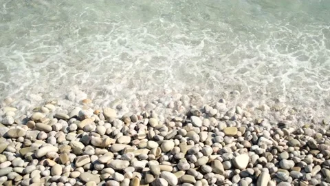 Sea waves splashing stony beach on top view, flat lay. Stock Footage 137776653