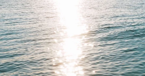 Sea waves with sun lights star with bokeh and sky reflection in summer day. Blue Stock Footage 112801536