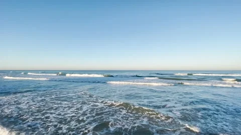 Sea waves at sunrise, sun rays on the sea during sunrise Stock Footage 147069483