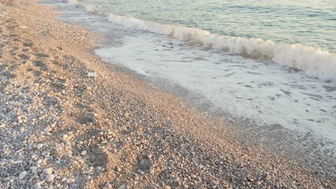 Sea waves at sunset beach. Adriatic sea. Pebbles beach seashore. Coastline waves Stock Footage 125043471