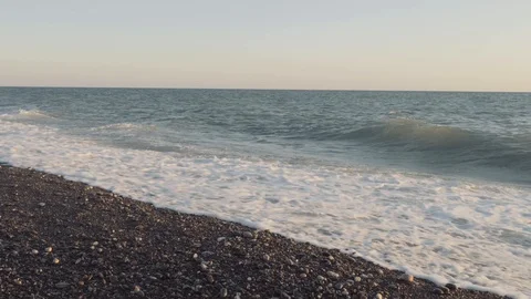 Sea waves at sunset. Beautiful waves break on a rocky beach 스톡 동영상 113878414