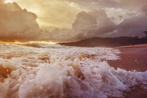 Sea waves on the sunset cloudy sky background Stock Photos