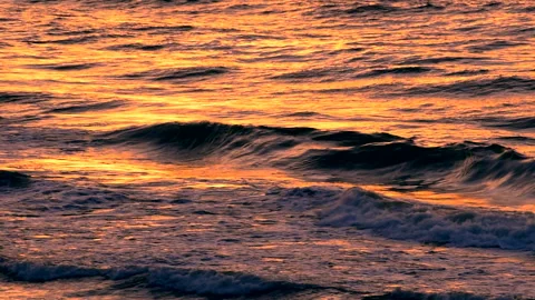 Sea waves of sunset with light reflection by the beach, close up, slow motion. Stock Footage 233342002