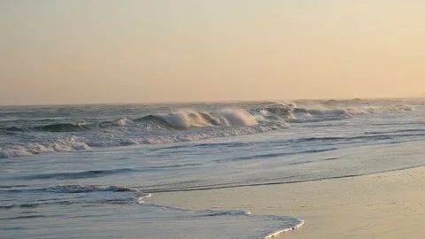 Sea Waves - Sunset waves crash onto shore - Pan to sea Vídeos de archivo 244686202