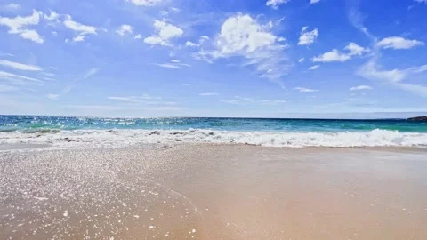 Sea waves surf on the sand beach during summer day Video stock 224518669