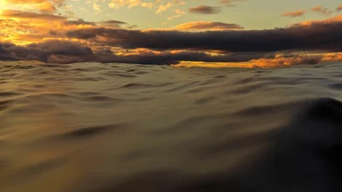 Sea waves under the cloudy sky by sunset Stock Footage 73566647