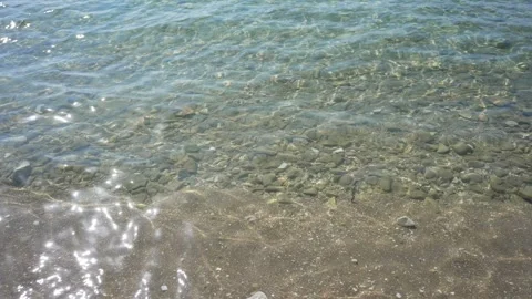 Sea waves washing over pebble beach with crystal water. Stock Footage 332226266
