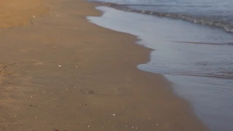Sea waves washing over sand close up view slow motion 動画素材 119439953