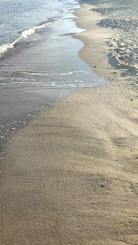Sea waves with white foam rolling sandy beach seashore sunny autumn day Stock Footage 292863318