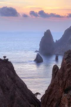 Seacoast with cliffs at sunset Stock Photos