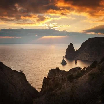 Seacoast with cliffs at sunset Stock Photos