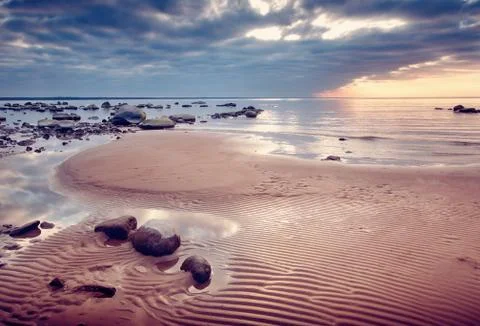 Seacoast at sunset Stock Photos