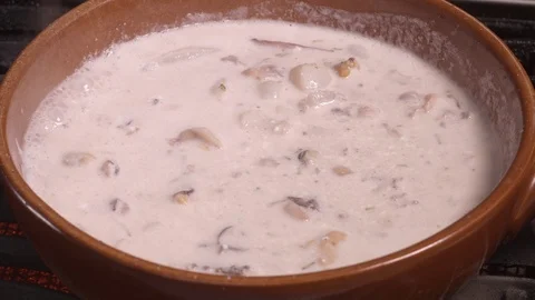 Seafood chowder boiling in a clay pan in UHD Stockbeeldmateriaal 94661210
