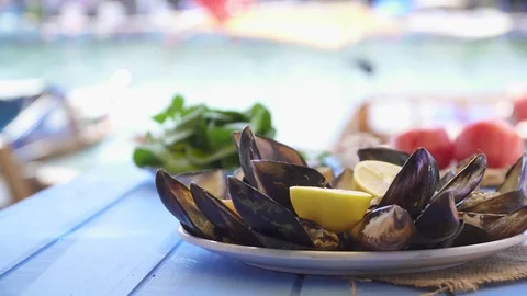 Seafood Dish open and ready mussels on blue table at restaurant  Stock Footage 80309778