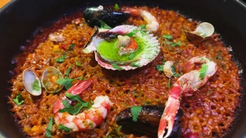 Seafood paella, top view, served on a wooden table. Stock Footage 336682237