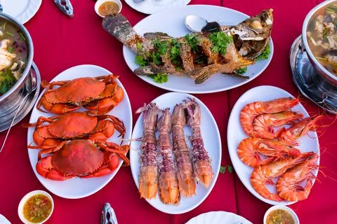 Seafood on the red dining table Foto stock