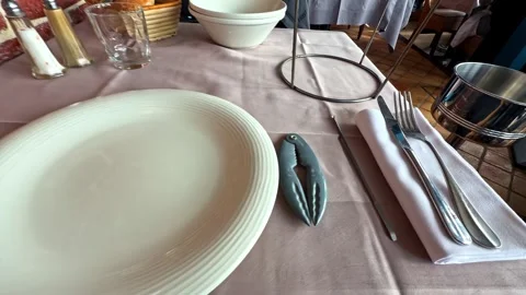 Seafood Restaurant Table Setting with Lobster Cracker and Silverware in Cancale Stock Footage 333720539