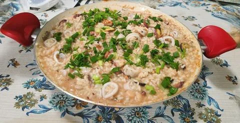 Seafood risotto in a decorative pan Stock Photos