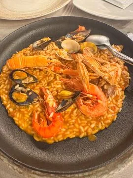 Seafood Risotto Served on a Table with Cutlery Foto stock