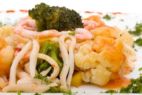 Seafood salad with squid and fresh vegetable, isolated on white Stock Photos