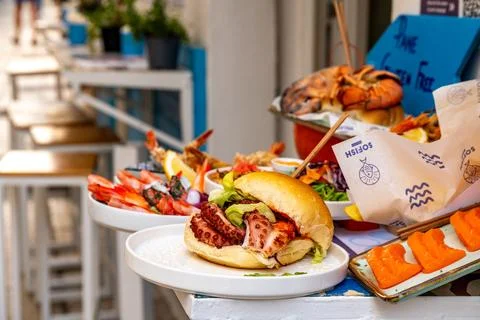 Seafood sandwich and assorted fish on outdoor counter 库存照片