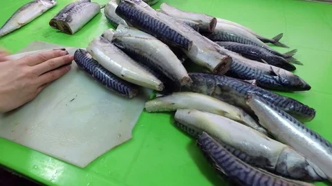 Seafood on the table. Mackerel. Cut off the tail of the fish. Frozen fish. Video stock 83966130