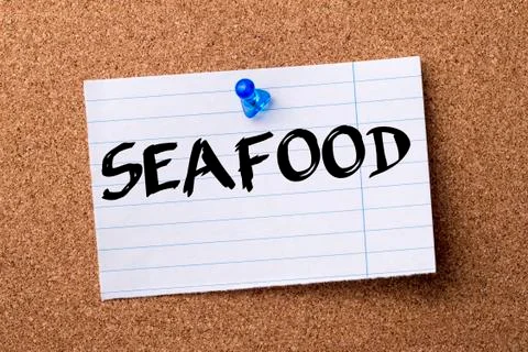 SEAFOOD - teared note paper pinned on bulletin board Stock Photos