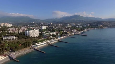 Seafront of Alushta in Crimea from drone in spring with piers cuts Black sea Video stock 78767227