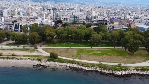 Seafront Park with Green Lawn Trees and Urban Skyline Stock Footage 343993914