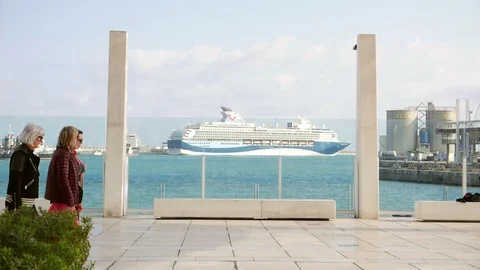 Seafront promenade with a ferry in the background behind a glass window Stock Footage 106339659