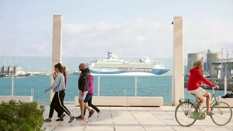 Seafront promenade with a ferry in the background behind a glass window Stock Footage 106340029