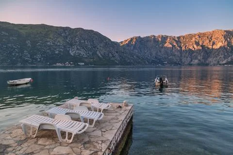 Seafront with sea and mountain in sunset time Stock Photos