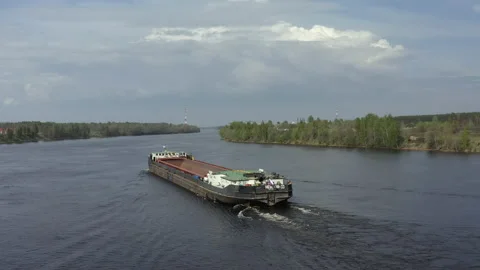 A seagoing cargo ship sails along the river Stock-Footage 155184686
